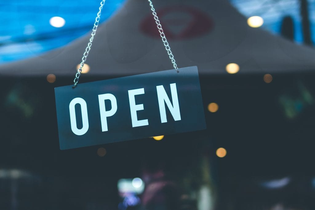 Photo :sign hanging, reads "open"