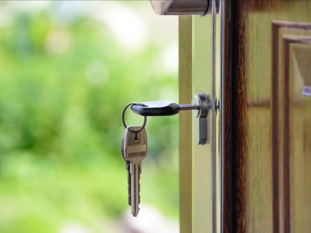 key hanging from a keyhole in a door
